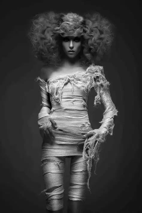 Grayscale portrait of a female model in a mummy horror costume