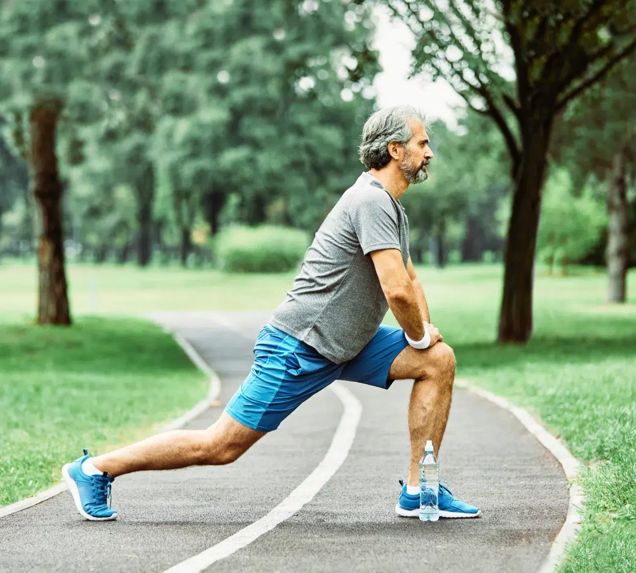 older man stretching before running