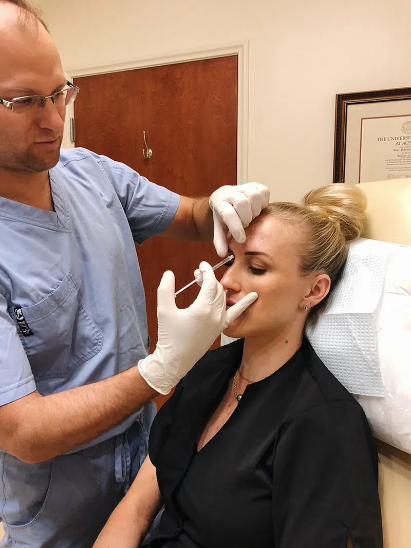 Woman getting neuromodulators in her temple