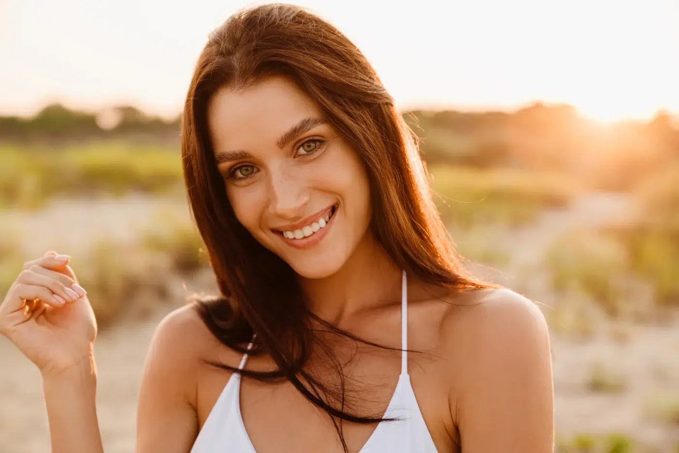 young brunette woman smiling and looking at camera hydrafacial black diamond