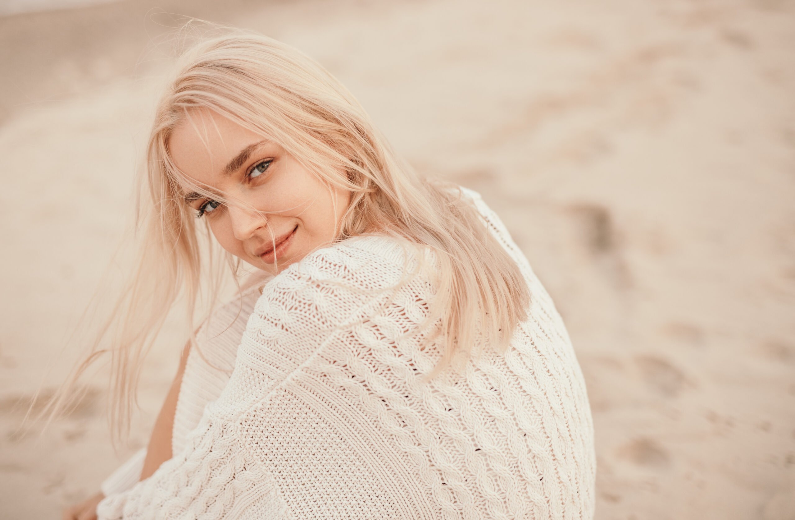 Magnificent young girl on seashore in cold windy day